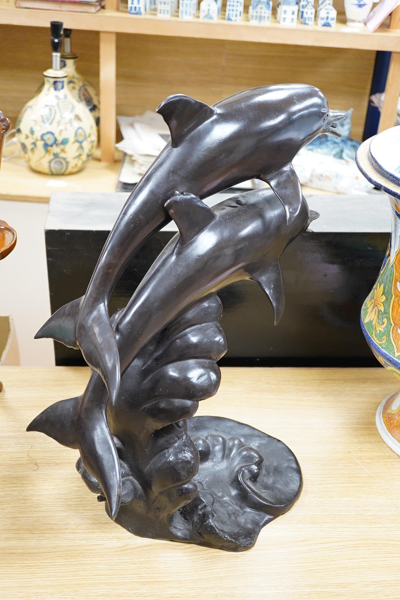A large contemporary bronze dolphin fountain water feature, 61cm high